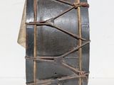 a drum with a rope wrapped around it on a white surface