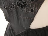 close up of the back of a black dress with black lace on it