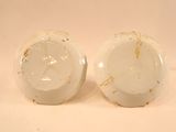 two white bowls sitting next to each other on a table
