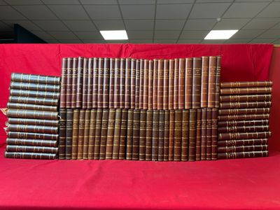 a pile of old books sitting on top of a red table