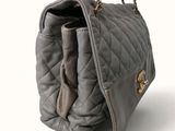 a gray purse with a gold chain hanging from it