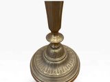an image of a brass candle holder on a white background