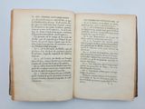 an open book on a table with a white background