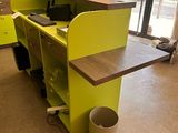 a green desk with a computer on it in a room