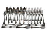 a lot of silver spoons and forks on a white surface