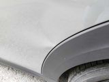 a close up of a car ' s front fender with a flat tire