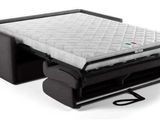 a bed that has a mattress on top of it