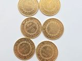 a set of five gold coins with the names of different countries