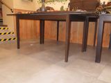 two tables that are sitting in the middle of a room