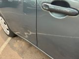 a close up of a car door handle with a sticker on it