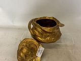 pair of gold plated vases on clear acrylic base