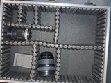 a metal case with a camera and a lens inside of it