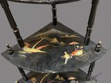 a three tiered table with a decorative design on it