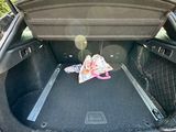 a trunk of a car with a bag of food in the trunk