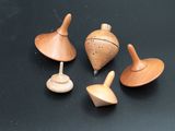 several small wooden toys are sitting on a black surface