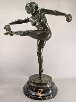 bronze statue of a female dancer on a marble base