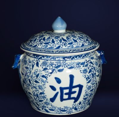 a blue and white jar with chinese writing on it