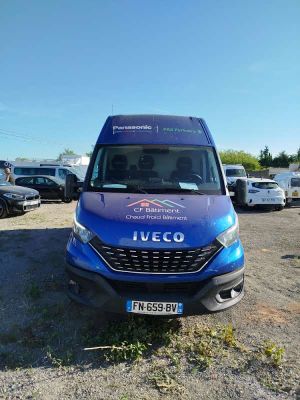 a blue van that is parked in a parking lot