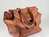 leather tote bag with shoulder strap and zipper closure
