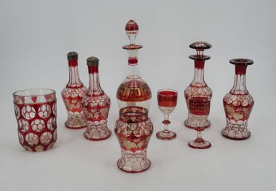 a group of red and white glass vases and wine glasses