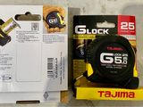 a box of tape and a tape measure sitting on a table