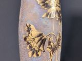 a vase that is sitting on a table in front of a wall