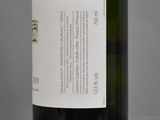 a bottle of wine sitting on a table with a label on it