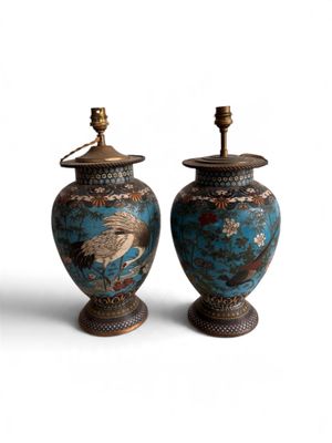 pair of asian vases with cranes on them on a white background