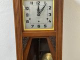 a wooden clock with a bell in the middle of it