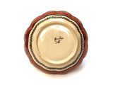 a red and white plate with a bird on it