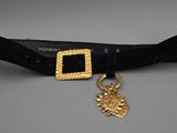 a close up of a belt with a gold buckle on it