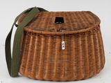 a close up of a wicker basket with a green strap