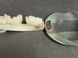 a magnifying glass and a carved object on a table