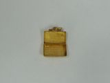 an image of a small gold purse sitting on top of a white surface