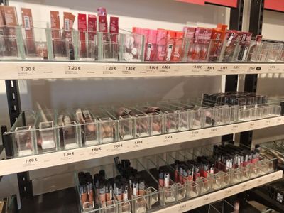 a lot of makeup products on the shelves in the store
