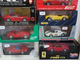 many different models of cars in boxes on the table