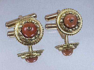 pair of gold tone cufflinks with a coral stone center