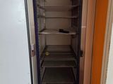 an open refrigerator in the corner of a room