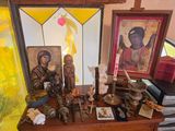 many religious items on a wooden table in a room