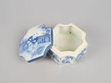 a blue and white box with a lid on a table