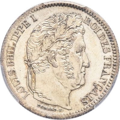 a close up of a coin on a white surface