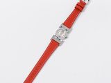 a close up of a watch on a white surface with a red strap