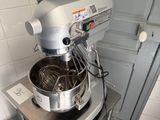 a mixer that is sitting on a stand in a kitchen