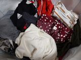 a pile of clothes that is sitting on a couch