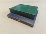 two boxes sitting on top of each other on a table