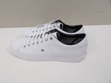 a close up of a pair of white sneakers on a table