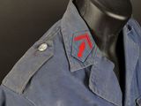 a blue jacket with a red heart on the chest