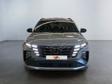 the front view of a silver suv parked in a showroom