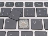 a small piece of plastic sitting on top of a laptop keyboard