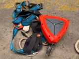 a backpack and other items on the ground next to a fire hydrant